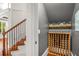 Hallway featuring hardwood stairs and unique custom built-in wine storage at 201 Hunley Ct, Alpharetta, GA 30005
