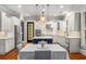 Open-concept kitchen with stainless steel appliances, an island, and dining area at 201 Hunley Ct, Alpharetta, GA 30005