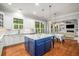 Bright kitchen with an island, white cabinets, marble countertops, and hardwood floors at 201 Hunley Ct, Alpharetta, GA 30005