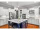 Modern kitchen featuring stainless steel appliances, an island, and white cabinetry at 201 Hunley Ct, Alpharetta, GA 30005