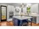 Gourmet kitchen with stainless steel appliances, island with seating, and backyard view at 201 Hunley Ct, Alpharetta, GA 30005