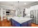 Spacious kitchen with stainless steel appliances, an island, and dining area with pendant lighting at 201 Hunley Ct, Alpharetta, GA 30005