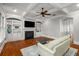 Cozy living room boasts a fireplace, built-in shelving, and hardwood floors at 201 Hunley Ct, Alpharetta, GA 30005