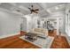 Spacious living room with hardwood floors, neutral paint, and a view to the kitchen at 201 Hunley Ct, Alpharetta, GA 30005