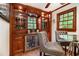 Bar includes a wine cooler, bar stools, and custom cabinetry, creating the perfect space for relaxation at 4111 Mcclatchey Ne Cir, Atlanta, GA 30342