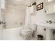 Cozy, well-lit bathroom featuring a shower-tub combo and a coordinating pedestal sink at 4111 Mcclatchey Ne Cir, Atlanta, GA 30342