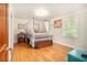 Bedroom with hardwood flooring, canopy bed, and a large window offering natural light at 4111 Mcclatchey Ne Cir, Atlanta, GA 30342