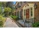 Charming entryway with a brick walkway, black shutters, and a red front door with sidelights at 4111 Mcclatchey Ne Cir, Atlanta, GA 30342