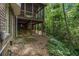 The exterior view shows the elevated screened porch and the home's foundation at 4111 Mcclatchey Ne Cir, Atlanta, GA 30342