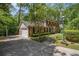 Classic brick home with a driveway, attached garage, manicured lawn, and mature trees at 4111 Mcclatchey Ne Cir, Atlanta, GA 30342
