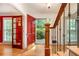 Bright foyer with hardwood floors, staircase and red door offers a warm welcome at 4111 Mcclatchey Ne Cir, Atlanta, GA 30342