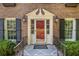 Charming red front door framed by sidelights and black shutters adds character to this brick home at 4111 Mcclatchey Ne Cir, Atlanta, GA 30342