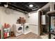 Basement laundry area boasts modern washer and dryer hookups and exposed ceiling rafters at 4111 Mcclatchey Ne Cir, Atlanta, GA 30342