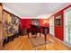 A dedicated piano room features hardwood floors, red accent walls, and natural light at 4111 Mcclatchey Ne Cir, Atlanta, GA 30342