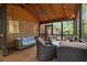 Relaxing screened porch featuring wood ceiling, brick wall, porch swing, and outdoor seating area at 4111 Mcclatchey Ne Cir, Atlanta, GA 30342