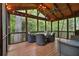 Relax on this screened porch, featuring a wood ceiling, outdoor furniture, and wooded views at 4111 Mcclatchey Ne Cir, Atlanta, GA 30342