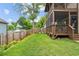 Backyard featuring a lush lawn, a wood fence, and a screened-in porch at 461 Silver St, Buford, GA 30518