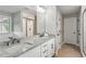 Modern bathroom with double vanity, granite countertop, and a glass-enclosed shower at 461 Silver St, Buford, GA 30518