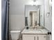 Clean and modern bathroom with granite countertops, a mirror, and a shower with a curtain at 461 Silver St, Buford, GA 30518