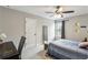 Well-lit bedroom featuring carpet floors, a ceiling fan, and ample natural light at 461 Silver St, Buford, GA 30518