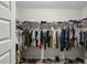 Walk-in closet with ample hanging space and shelving for organized storage at 461 Silver St, Buford, GA 30518