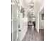 Entryway of home with hardwood floors and view into the living room at 461 Silver St, Buford, GA 30518