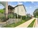 Landscaped home with a fenced yard, manicured landscaping, and covered porch at 461 Silver St, Buford, GA 30518