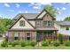 Charming two-story home with brick facade, manicured lawn, and black iron fence at 461 Silver St, Buford, GA 30518
