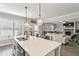 Bright kitchen with a large island, stainless steel appliances, and seamless access to the living area at 461 Silver St, Buford, GA 30518