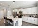 Modern kitchen featuring a quartz island with seating and white cabinets at 461 Silver St, Buford, GA 30518