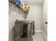 Modern laundry room with front loading machines and patterned tile flooring plus shelf storage at 461 Silver St, Buford, GA 30518