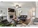 Spacious living room with hardwood floors, brick fireplace, and bright lighting at 461 Silver St, Buford, GA 30518