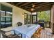 Relaxing covered porch with a dining area and grill, offering a perfect outdoor experience at 461 Silver St, Buford, GA 30518