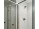 Modern walk-in shower featuring sleek white tiling and glass door at 461 Silver St, Buford, GA 30518