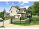View of the home's side yard, driveway, brick and siding details, and two-car garage at 461 Silver St, Buford, GA 30518