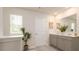 Bright bathroom featuring a double vanity with gray cabinets and a large mirror at 4946 Jatoba Rd, Acworth, GA 30101