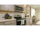 This open kitchen has stainless appliances, gray cabinets, and white subway tile backsplash at 4946 Jatoba Rd, Acworth, GA 30101