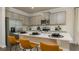 Bright kitchen features stainless appliances, gray cabinets, and a quartz countertop island with barstool seating at 4946 Jatoba Rd, Acworth, GA 30101