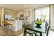 Well-lit kitchen and dining area with stainless steel appliances and a center island with seating at 4946 Jatoba Rd, Acworth, GA 30101