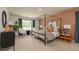 Beautifully decorated main bedroom with canopy bed, natural light, and modern furnishings at 4946 Jatoba Rd, Acworth, GA 30101