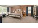 Bright main bedroom with canopy bed, chic side tables, and comfortable seating area at 4946 Jatoba Rd, Acworth, GA 30101