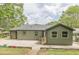 Large backyard with a freshly painted home exterior, concrete patio, and a well maintained lawn at 525 Rosemont Dr, Decatur, GA 30032