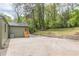Spacious backyard featuring a stone retaining wall and a freshly painted home exterior and door at 525 Rosemont Dr, Decatur, GA 30032
