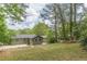 Spacious and well-maintained backyard featuring a freshly painted home exterior and lush greenery at 525 Rosemont Dr, Decatur, GA 30032