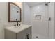 Modern bathroom with tiled shower and gray vanity and new fixtures at 525 Rosemont Dr, Decatur, GA 30032