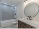 Stylish bathroom with modern vanity, round mirror and shower at 525 Rosemont Dr, Decatur, GA 30032