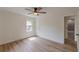 Bright bedroom features a ceiling fan and wood-look flooring at 525 Rosemont Dr, Decatur, GA 30032