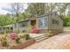 Charming home featuring a freshly painted exterior, complemented by vibrant flowers and new wooden stairs at 525 Rosemont Dr, Decatur, GA 30032