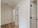 Hallway featuring white doors and trim plus wood flooring at 525 Rosemont Dr, Decatur, GA 30032