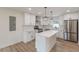 Modern kitchen with stainless appliances, white cabinets, quartz countertops, and subway tile backsplash at 525 Rosemont Dr, Decatur, GA 30032